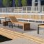 Thor deckchair with Stool on a wooden deck with modern urban background