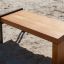 Thor bench made of wood and metal frame placed on sandy ground.