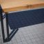 Thor table with metal legs on tiled outdoor surface.