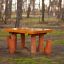 Table Nature with 4 stools made of natural wood placed outdoors in a forest setting