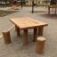 Natural wooden Table Nature with 4 stools in a park setting.