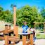 Children playing on Sand & Water Play 2 playground structure in a park.