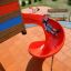 Child sliding down a red playground slide on Rubber Tiles 35.
