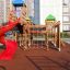Playground equipment with colorful towers, slide, and climbing net on Rubber Tiles 35.