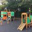 Big Tractor playhouse with slide in a playground.