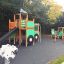 Big Tractor playhouse with slide in a playground.
