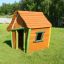 Wooden playhouse on green lawn - Crooked House.