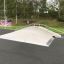 Skate park ramp called Fun Box 8 surrounded by greenery.