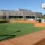 Multiarena Wooden sports field with soccer and basketball facilities in a schoolyard.
