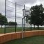 Multiarena Wooden with basketball hoop in a park by a lake.