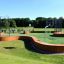 Multiarena Wooden sports field with basketball hoops and green artificial turf