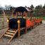 Playground Locomotive with cars train playhouse with wooden structure.