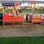 Children playing in a Locomotive with cars train playhouse on the playground.