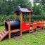 Train-themed playhouse for children in a park.