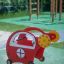 Red Copter rocking spring rider on playground.
