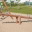 Nature Seesaw made of wood in a sunny playground
