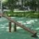 Nature Seesaw in a playground with wooden design and metal handles.