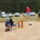 Children playing on Nature Seesaw in a sandy playground.