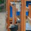 Sand & Water Play III playground with wooden structure and chain buckets for sand