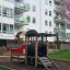 Playground with Locomotive train playhouse in front of modern apartment buildings.