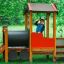 Locomotive train playhouse wooden playground equipment with child playing outdoors