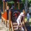 Children playing in a Locomotive train playhouse outdoors.