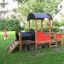 Children's playground with a wood and metal Locomotive train playhouse.