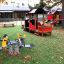 Locomotive train playhouse on a playground with a spring rider.