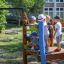 Children playing on Captain's Bridge playground structure in a park.