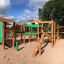 Outdoor wooden playground structure with green panels, Rope Center.