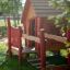 Wooden playhouse for children with red accents, Anna's Playhouse.