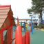 Anna's Playhouse wooden playground with colorful play structures for children.