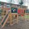 Wooden Jungle castle with slide in a playground.