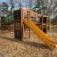 Playground Jungle castle with slide made of wood and decorated with animal motifs.