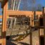 Jungle castle with slide featuring a wooden play structure and climbing net at a playground.