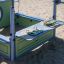 Outdoor playset on sandy playground for children called Pluto.