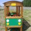 Wooden bus-shaped playground structure with green and yellow accents.