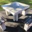 Outdoor chess table set with four wooden benches.