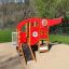 Red and yellow Helicopter children's playground structure with slide and climbing features in a park