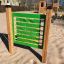 Find Pairs Board at playground in sandy area with wooden play structures in background.