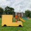 Yellow Van playground equipment on a grassy field.