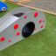 Children's playground slide, Dottie II single slide with red dots on a grassy area.