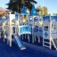 Playground structure resembling a castle with blue and white color scheme and slides, named Winter M