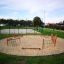 Outdoor playground Trim Trail Nature III with wooden structures and climbing nets.