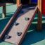Wooden ramp and climbing holds of Knight's Castle playhouse with slide.