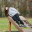 Roman bench (back muscles) in use by a person for an outdoor workout.