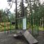 Information Board NAF MEDIUM, outdoor fitness station in park, green exercise equipment.