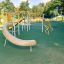 Orion steel structure playground equipment with a slide and climbing elements.