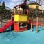 Tower playhouse with slide on playground.