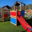 Outdoor Tower Playhouse with Slide in a playground setting.